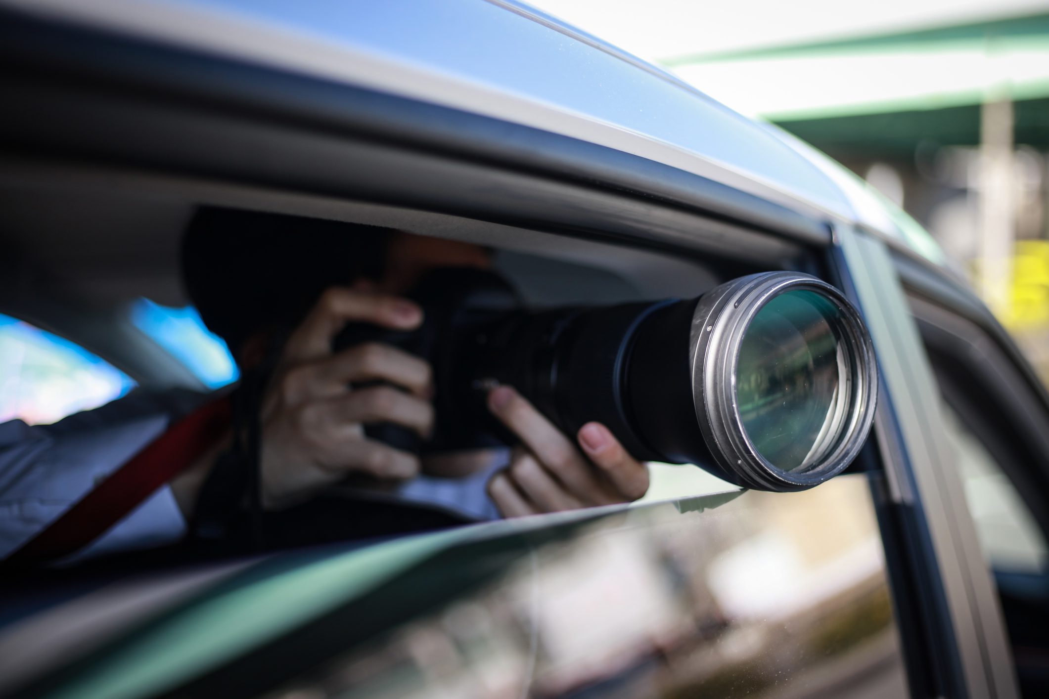 Man taking pictures inside the car using DSLR